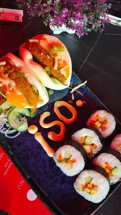Guests enjoying sushi boats, pumpkin bao, chilli paneer, yakisoba noodles, and mochi at Iso Sushi Nottingham.