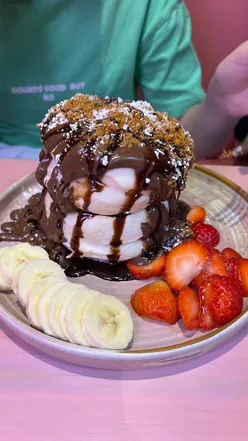 Customers enjoying fluffy Japanese soufflé pancakes at a busy café in Chiswick, west London.