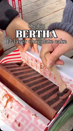 Indulgent twelve-layer chocolate cake at a cafe, perfect for sharing among chocolate lovers in Manchester.