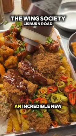 New location announcement for The Wing Society on Lisburn Road, featuring a competition in comments.