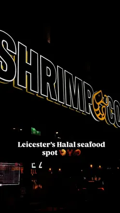 Couple enjoying a steak meal with garlic butter sauce at Shrimp & Co, a seafood restaurant in Leicester.