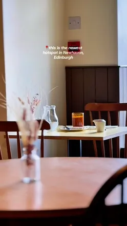 Couple enjoying shared plates at Norah restaurant in Newhaven, featuring locally sourced ingredients and stunning décor.