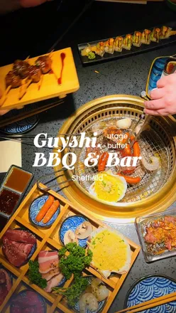 Guests enjoying a Japanese charcoal BBQ buffet experience with sushi and drinks at Guyshi in Sheffield.