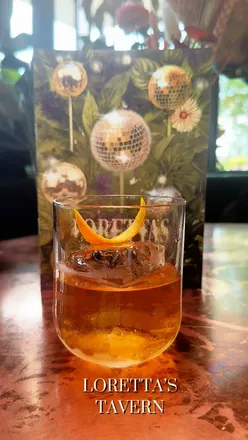 Loretta's Tavern in Liverpool One, showcasing lush greenery and delicious cocktails, perfect for dates and catch-ups.