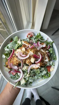 Colorful plate showcasing a variety of fresh foods including tomatoes, avocado, eggs, and coffee for a healthy meal.