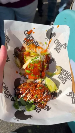 Foodies enjoying hot wings and craft beer at Wing Fest UK in Manchester, celebrating summer vibes and delicious eats.