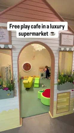 Family enjoying pancakes and coffee at a vibrant new eco-friendly store on Loughton High Road, surrounded by plants.