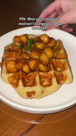 Person enjoying a meal, embracing balance in health and food freedom, smiling at the journey to wellness.
