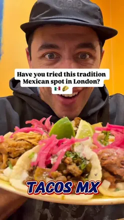 Delicious spread at Tacos MX in Kingston: nachos, tacos, quesadillas, and Beef Birriadillas in a vibrant setting.