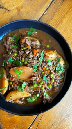 Cozy slow cooker beef brisket pot roast with potatoes and veggies, perfect for autumn comfort food.