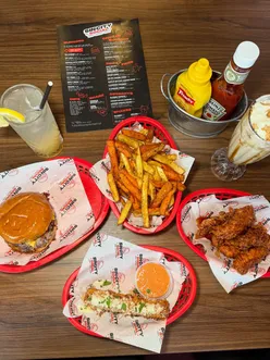 Juicy 'Po-Po' burger and gooey mozzarella sticks at Sin City Social, Liverpool, with vibrant decor and delicious drinks.