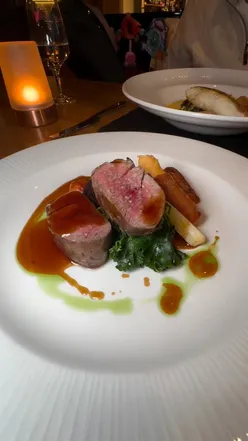 Diners enjoying seasonal dishes like venison and halibut at Rafters restaurant, Celtic Manor, South Wales.