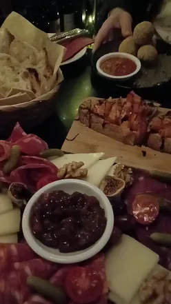 Couple enjoying wine and delicious nibbles at Cecila's Wine House near London's West End theatre district.