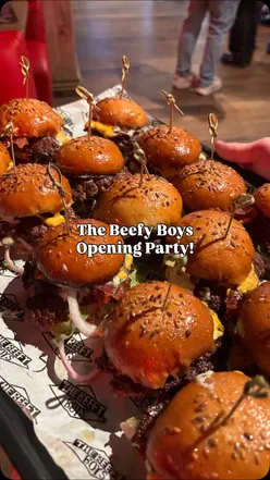 Guests enjoying burgers and lively atmosphere at the grand opening party of Westgate Oxford.