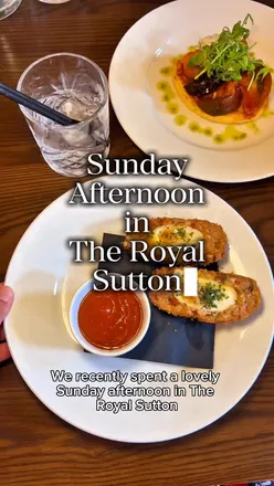 Couple enjoying a tasty Sunday roast and interactive darts at The Royal Sutton, Sutton Coldfield, Birmingham.
