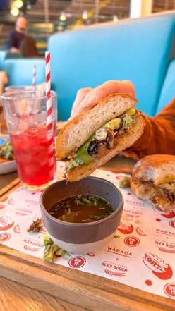 Limited-edition Birria Torta sandwich by Alex Gooch at Wahaca Cardiff, featuring slow-cooked beef and tasty toppings.
