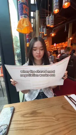Group enjoying a variety of Indian dishes at Indian Tiffin Room, Manchester, including chilli squid and dosa.