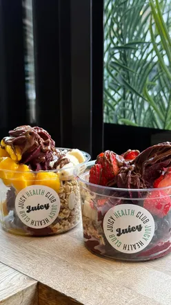 Delicious açai bowl topped with strawberry, blueberry, mango, Nutella, and soft serve at Juicy UK in Glasgow.