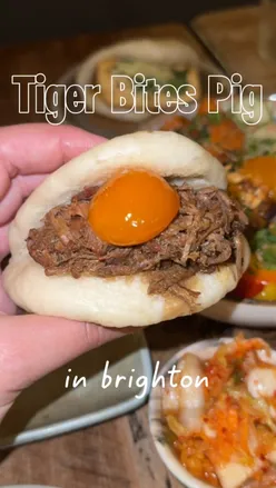 Delicious bao buns and rice bowls at Tiger Bites Pig in Brighton, featuring melt-in-mouth pork belly and crispy chicken.