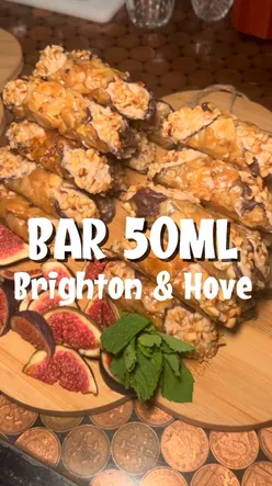 Guests enjoying signature Mediterranean cocktails and snacks at Bar 50ml's launch party in Brighton, UK.