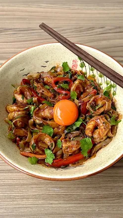 Delicious spicy tomato and parmesan prawn noodles, featuring fresh ingredients and vibrant colors in a wok setting.
