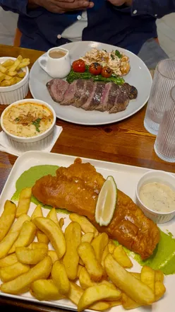 Enjoying a lively comedy night at Eastern Jam with delicious fish and chips in Birmingham.