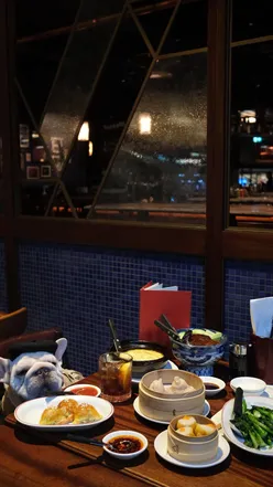 Enjoying dim sum and roast duck at The Duck and Rice, Battersea Power Station, with a dog-friendly terrace. 🍽️🐶