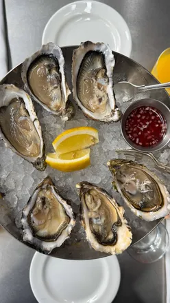 Brunch spread at Noisy Oyster in London featuring oysters, tater tots, and crab omelette—perfect for foodies!