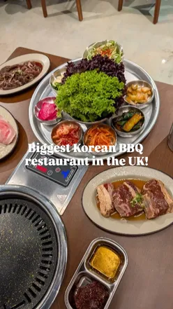 Guests enjoying Korean BBQ dishes and soju cocktails at Bullgogi Manchester, the UK's largest Korean BBQ restaurant.