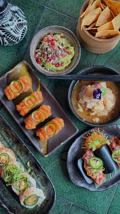 Mocktail and sushi at Los Mochis, a vibrant Tokyo-Tulum fusion restaurant in London, perfect for a luxurious yet laid-back vibe.