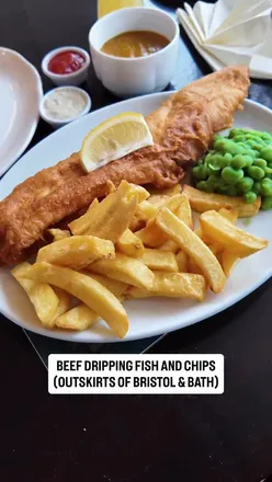 Enjoying beef dripping fish and chips at The Haynes, a historic chip shop in High Littleton near Bristol.