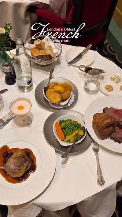 Elegant Sunday lunch at L’Escargot in Soho, London featuring French cuisine and delectable dishes like escargots and duck confit.