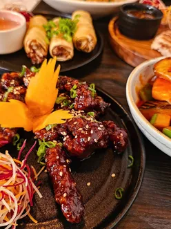 Enjoying crispy chilli beef at Mangosteen Bristol with smiles after a delicious visit to this Asian cuisine hotspot.