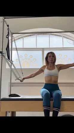 Pilates Tower equipment in use during a training session with expert instructor Amridler, promoting strength and flexibility.