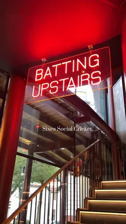 Visitors enjoying cricket activities at Sixes Social Cricket in Headingley on a rainy day.