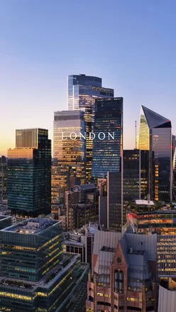 Nighttime view of London Bridge and St. Paul's Cathedral, illuminated city lights reflecting on the Thames River.