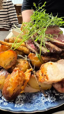 Guests enjoying farm-fresh meals at Castle Farm in Midford, showcasing rustic dining and vibrant, local dishes.