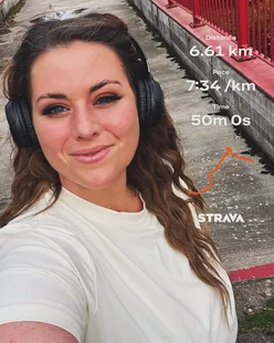 Runner celebrating a 6k run and Junior Parkrun with son, relaxing at home with a cup of tea and slippers.