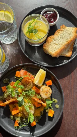 Dining at The Pheasant Inn, featuring modern dishes, cask ales, and a cozy log fire ambiance in a stunning renovated pub.