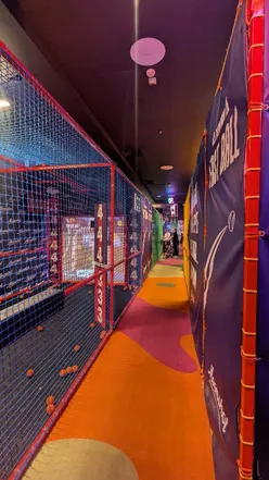 Friends enjoying baseball and arcade games at Moonshot, a fun activity spot in London.