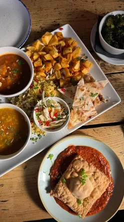 Autumn spread at The Spread Eagle London featuring vegan Moroccan platter, raviolo, Shamembert, and doughnut balls.