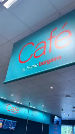 Three people enjoying affordable lunch at Home Bargains cafe, featuring hot food, drinks, and cakes for under £15.