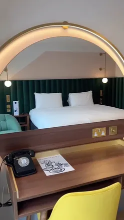 Stylish interior of Hotel Indigo London Clerkenwell, showcasing vibrant decor and cozy guest rooms in a chic atmosphere.