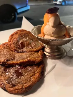 Enjoying caramel banana ice cream and brown sugar cookies at 74 Duke Mayfair, despite a caloric deficit struggle.