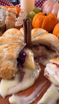 Baked Brie Puff Pastry Pumpkin with cranberry sauce, perfect for cozy seasonal gatherings.