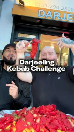 Participants tackle the world's biggest kebab challenge at Darjeeling Indian in Manchester.