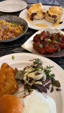 Indulging in a bottomless brunch at Zouk Tea Bar in Manchester, featuring Bollywood Benedict and vibrant cocktails.