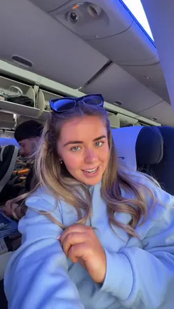 Passenger enjoying British Airways World Traveller Plus on flight to Orlando, excited for upcoming holiday adventures.