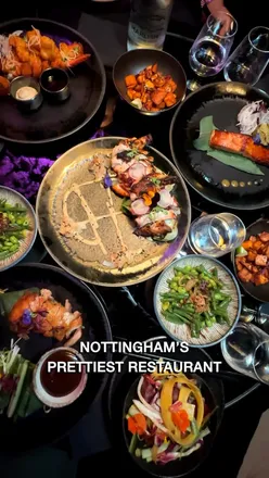 Beautiful dining space at Nosh Nottingham with cherry blossoms, cozy lighting, and elegant food for date nights.