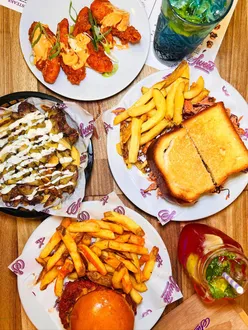 Customers enjoying burgers and shakes at Sweet Diner, Denton, Greater Manchester; a great halal dining experience.